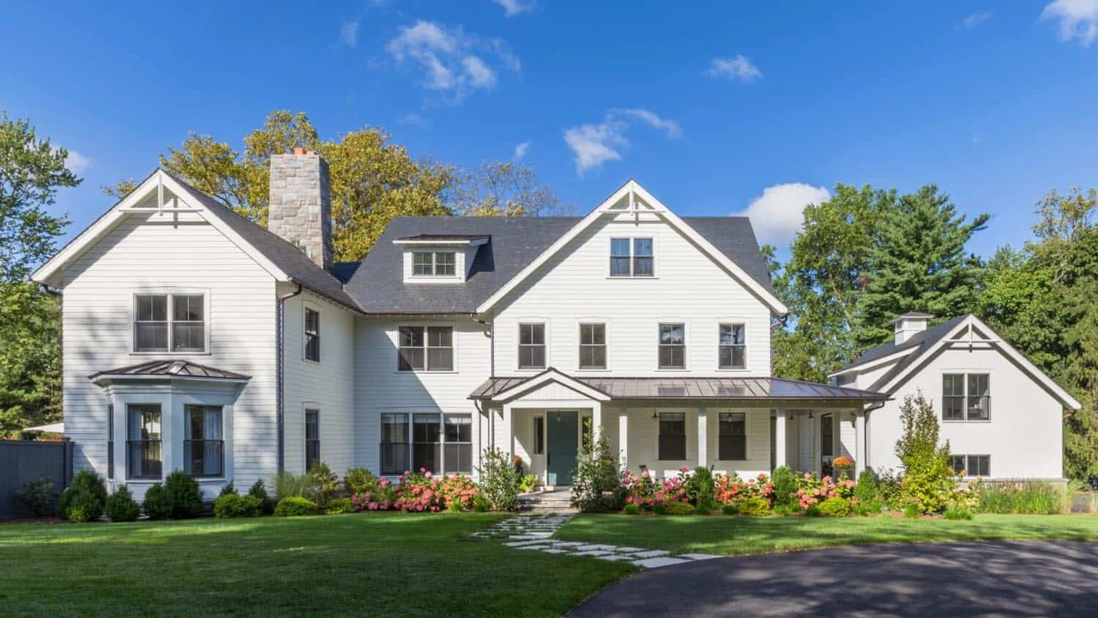 Exterior view of a renovated white home by Craftsman Home Improvement Inc.